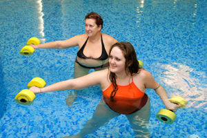 photo of an adult women and young woman on group training in water with dumbbells