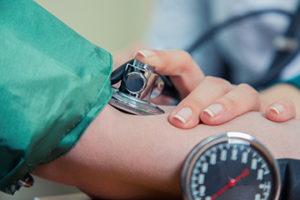 up close photo of doctor measuring patient’s blood pressure